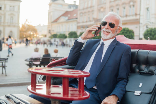istock Smiling businessman talking on phone 1064246224