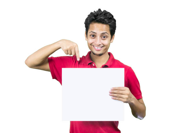 Young man pointing at a sign, isolated on white.