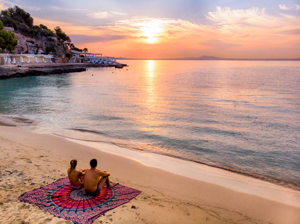 istock Couple alone laid down at the Beach at sunrise 1064250000