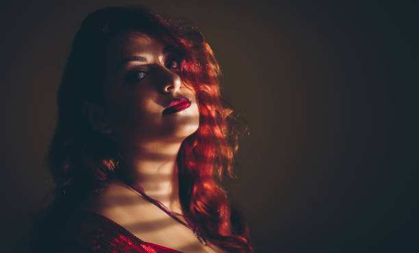 istock Young seductive woman under blinder shadow 1064250444