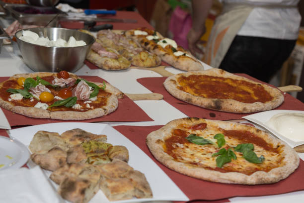 istock Pizza Maker who Prepares Delicious Pizzas with Cheese ad Tomatoes 1064250572