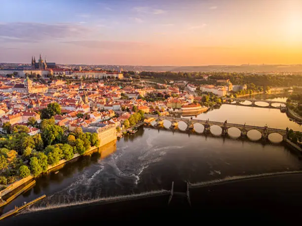 Photo of Aerial view of Prague Castle, cathedral and Charles Bridge at sunrise in Prague