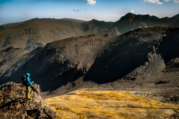 istock Anonymous tourist admiring view of mountains 1064261236