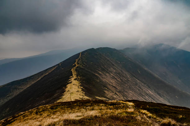 istock Rain clouds over mountain ridge. Bad weather is coming 1064266128