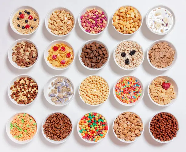 Photo of set of different cereals with milk on a white background