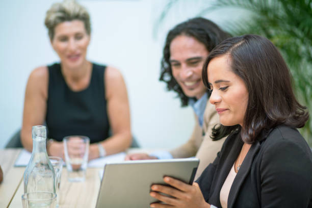 istock Group of Australian business people at table discussing work on digital tablet 1064269566