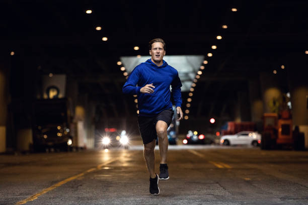 istock Athletic man running and getting fit in the city downtown after work 1064270936