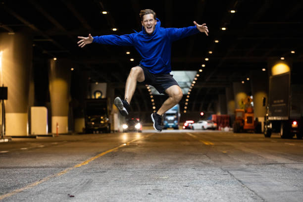 Athletic man running and getting fit in the city downtown after work in Los Angeles.
