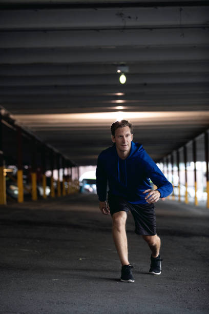 istock Athletic man running and getting fit in the city downtown after work 1064271358