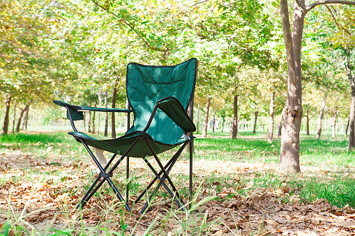 The green outdoor chair.  Having a picnic in the countryside.