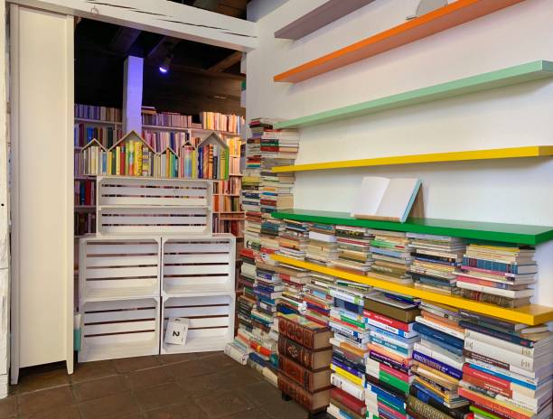 istock Planning the new library - unsorted book stacks and empty shelves 1064274090