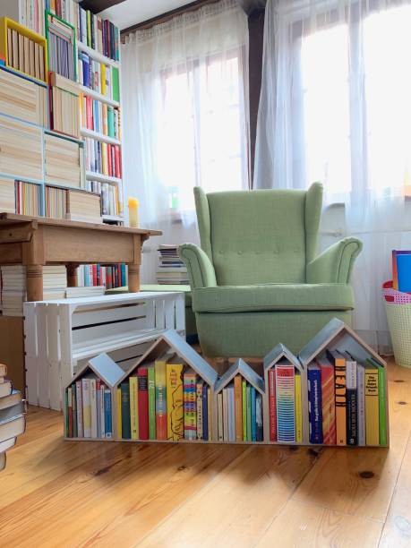 istock Little library house in front of bookshelves 1064275802