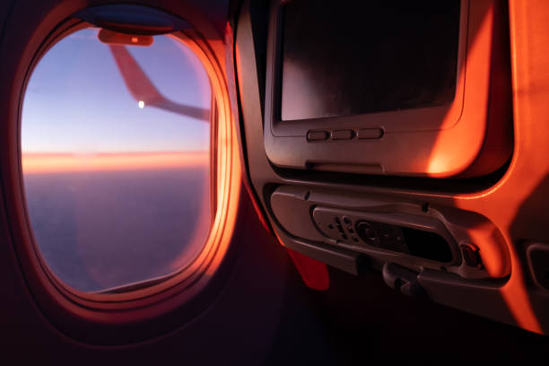 istock Seats, TV system and window inside an aircraft. Airplane interior in sunlight 1064276490