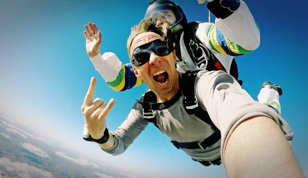 Skydive tandem selfie photo effect Skydiving shot with small camera exhilaration photos stock pictures, royalty-free photos & images