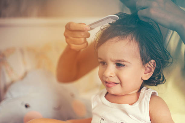 istock Mum brushing baby boy hair after bath 1064279748