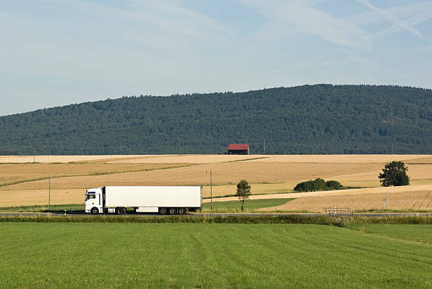 istock White truck driving through a summerly landscape 106428186