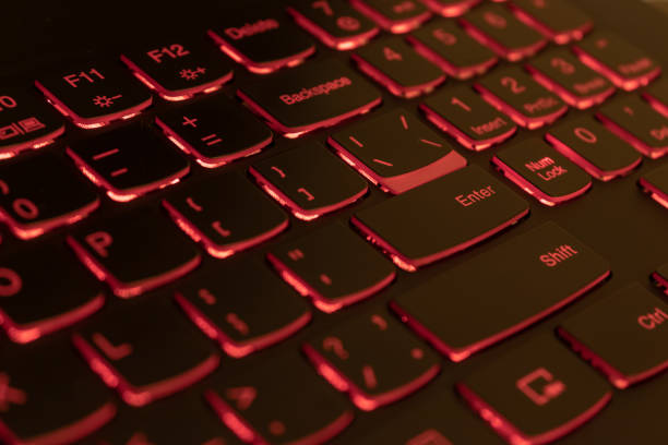 istock Red backlit laptop keyboard, hacking and blockchain concept 1064285104