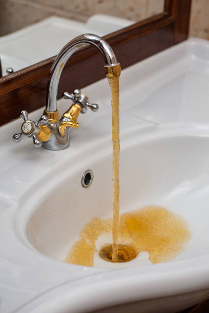 istock Dirty rusty water flows from the faucet 1064285942