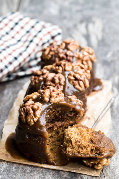 istock Sticky chocolate and walnut puddings on wooden table 1064286398