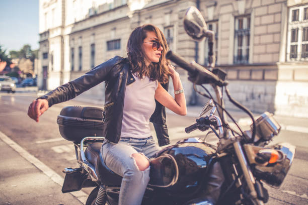 istock Young pretty fashioned girl sitting on her motorcycle 1064287670