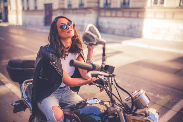 istock Young pretty fashioned girl sitting on her motorcycle 1064287892