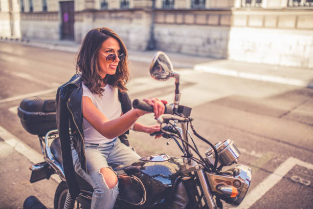 istock Young pretty fashioned girl sitting on her motorcycle 1064288042