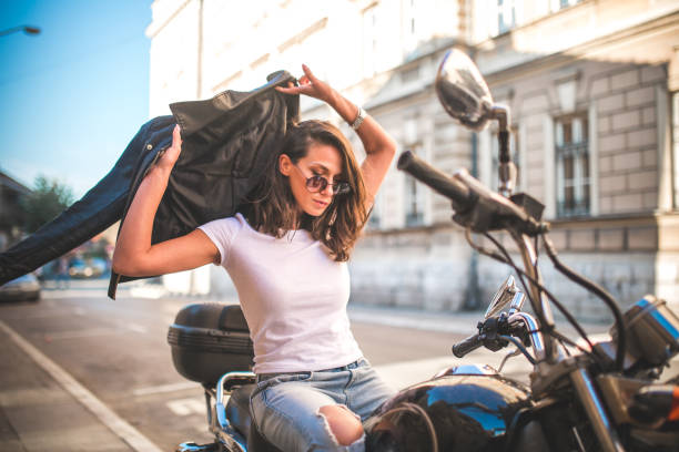 istock Young pretty fashioned girl sitting on her motorcycle 1064288122