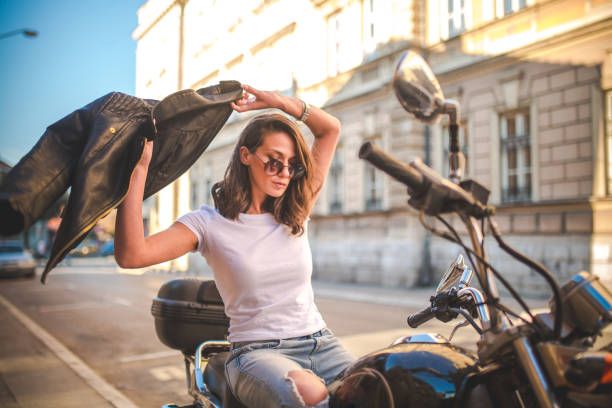 istock Young pretty fashioned girl sitting on her motorcycle 1064288252
