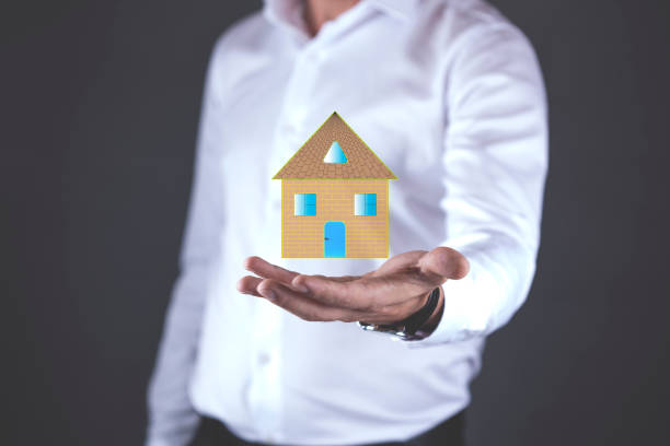 istock young man hand house  model in screen 1064288580