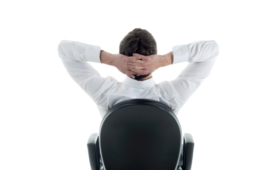 Rear view of a relaxed businessman with hands behind his head