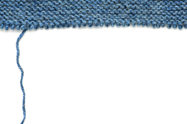 Unravelling knitted fabric Unravelling knitted fabric on white background sweater unravelling stock pictures, royalty-free photos & images