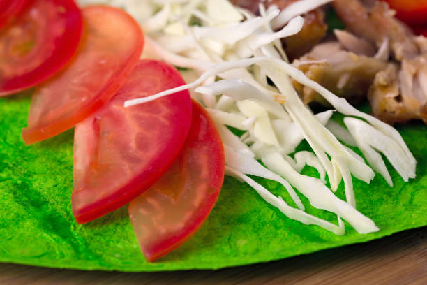 istock Ingredients for cooking shawarma lie on a pita bread. Middle Eastern dish to grill. 1064295304