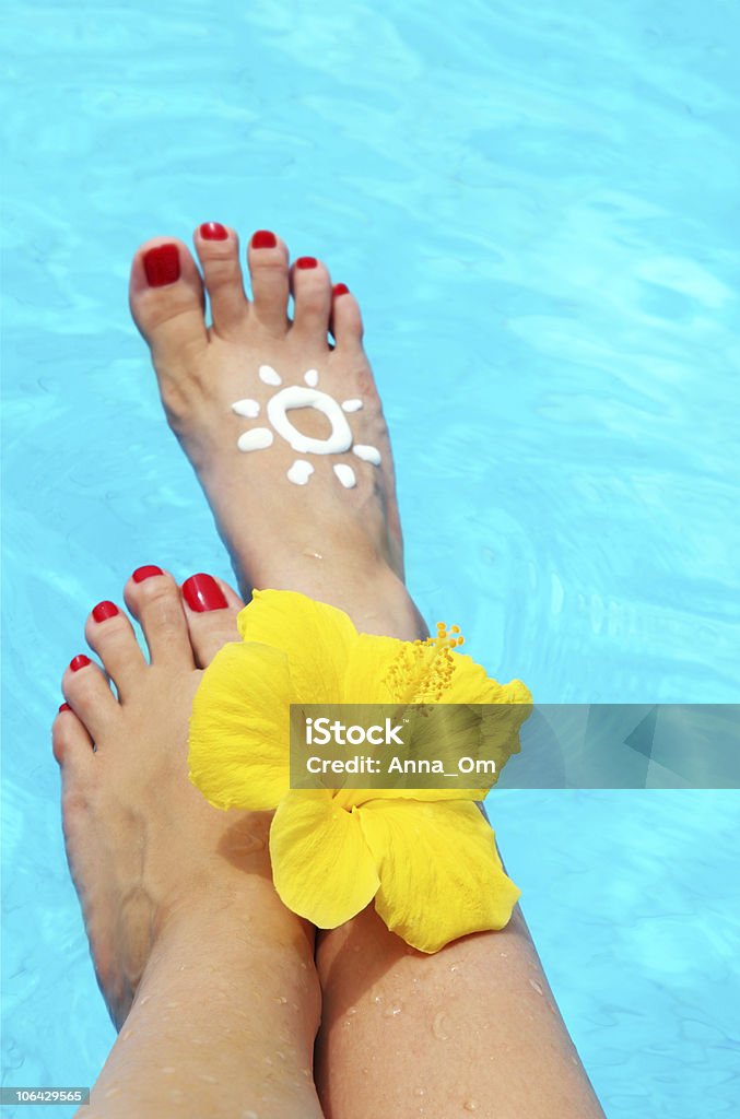 Beautiful female legs in the pool Beautiful female legs in the pool conceptual image of vacation Adult Stock Photo