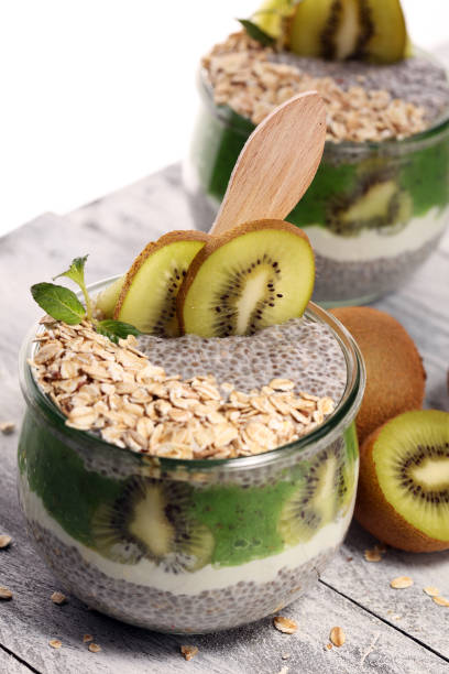 istock Healthy breakfast. chia pudding with kiwi and granola in glass on rustic background. 1064301052