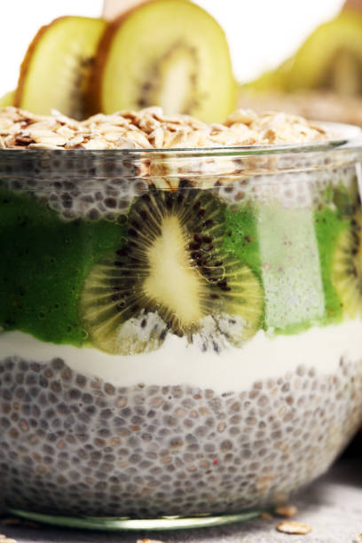 istock Healthy breakfast. chia pudding with kiwi and granola in glass on rustic background. 1064301216