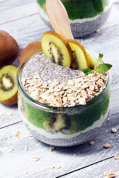 istock Healthy breakfast. chia pudding with kiwi and granola in glass on rustic background. 1064301426