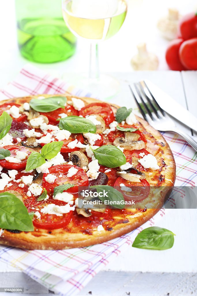 Pizza with mushrooms, tomatoes and cheese  Basil Stock Photo