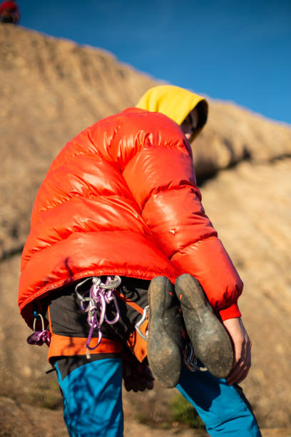 istock Man checking climbing partner on high rock 1064303560