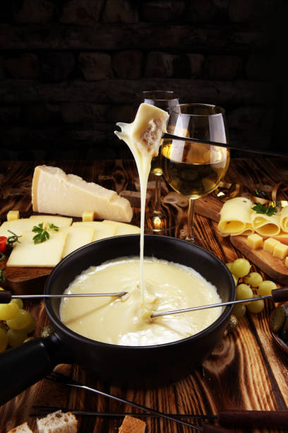istock Gourmet Swiss fondue dinner on a winter evening with assorted cheese 1064304352