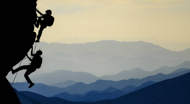 istock challenging rock climbing and accompanying friends 1064304926