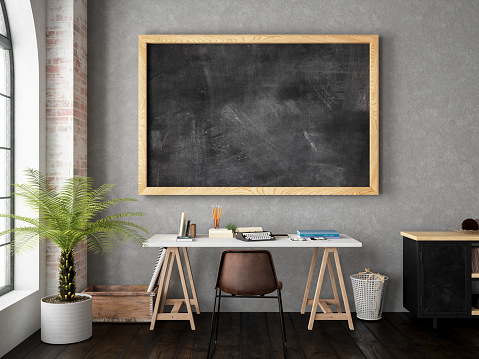 Cozy style office with blank black board on the wall