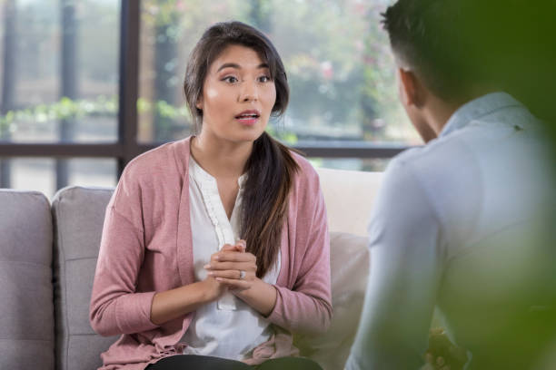 istock Vulnerable woman talks with mental health professional 1064312706