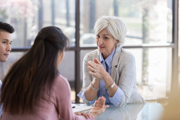 istock Serious counselor talks with young couple 1064312762