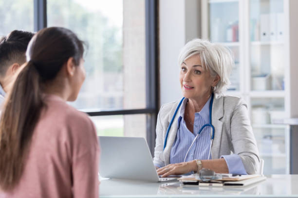 istock Serious doctor talks with young couple 1064312770