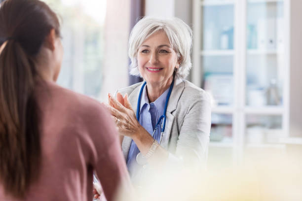 istock Cheerful senior doctor talks with patient 1064312772