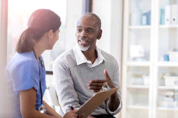 istock Cheerful senior man talks with physician 1064312886