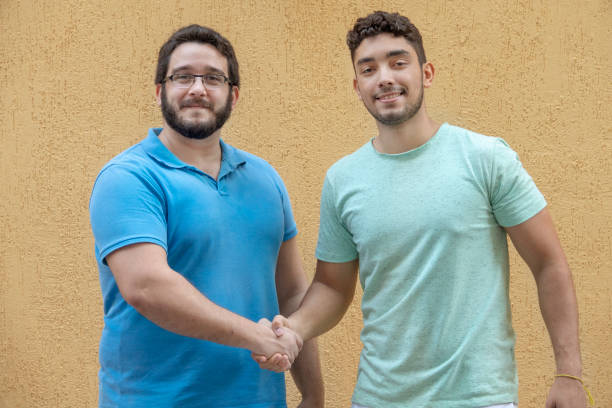 two young brazilian men making business - polo shirt two people men working imagens e fotografias de stock