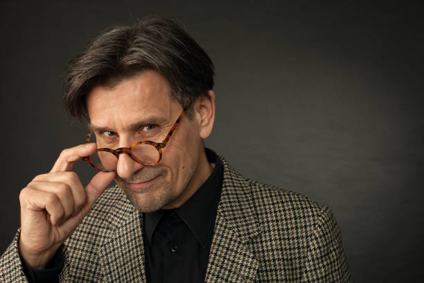 istock studio portrait of 60 year old man on black background 1064317512