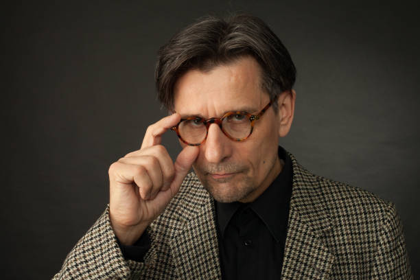 istock studio portrait of 60 year old man on black background 1064317558