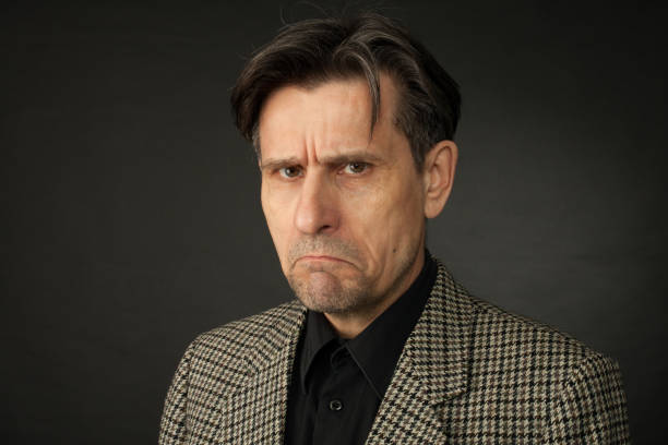 istock studio portrait of 60 year old man on black background 1064322104